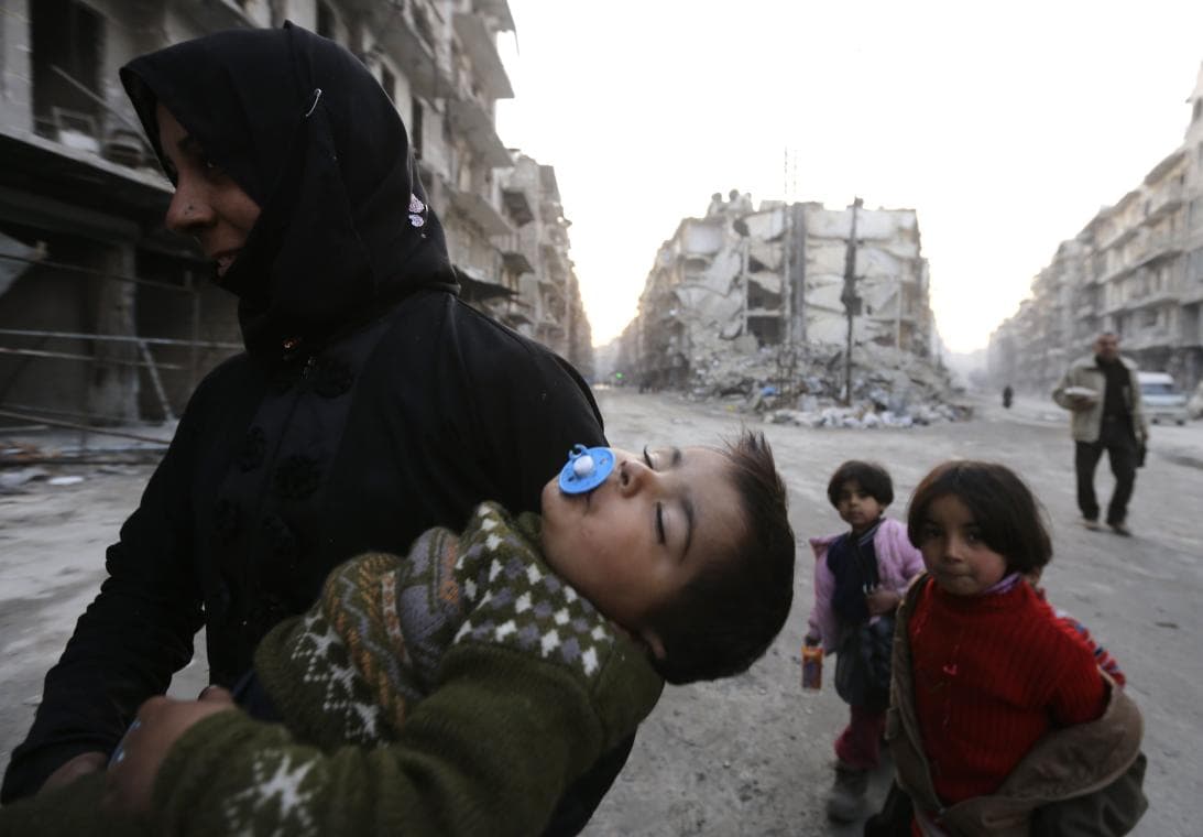 A woman with her son and two other children in Aleppo.