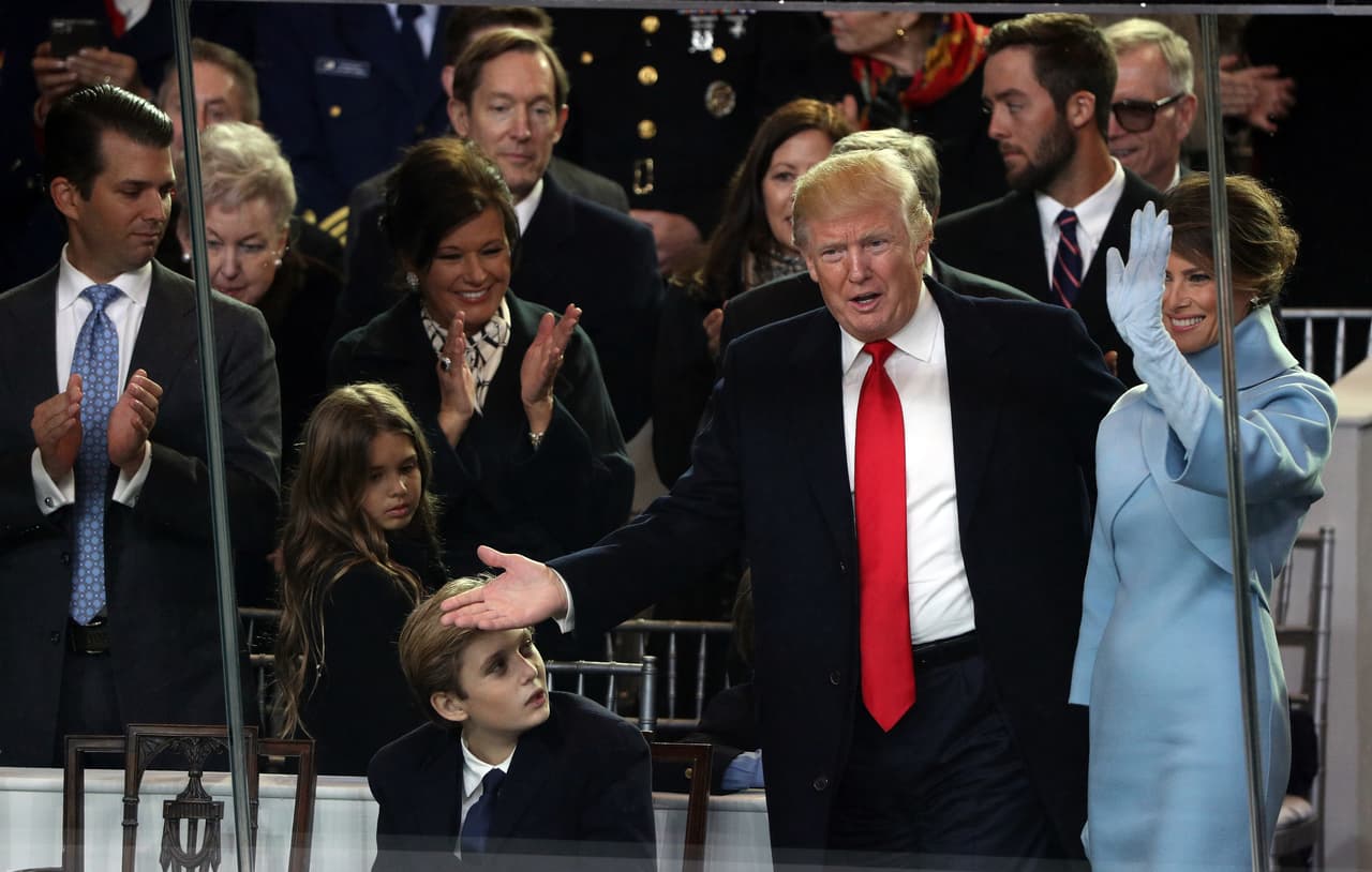 WASHINGTON, DC - JANUARY 20: (R-L) First lady Melania Trump, U.S. President Donald Trump and Barron Trump watch the Inaugural Parade from the main reviewing stand in front of the White House on January 20, 2017 in Washington, DC. Donald J. Trump was sworn in today as the 45th president of the United States. (Photo by Patrick Smith/Getty Images)