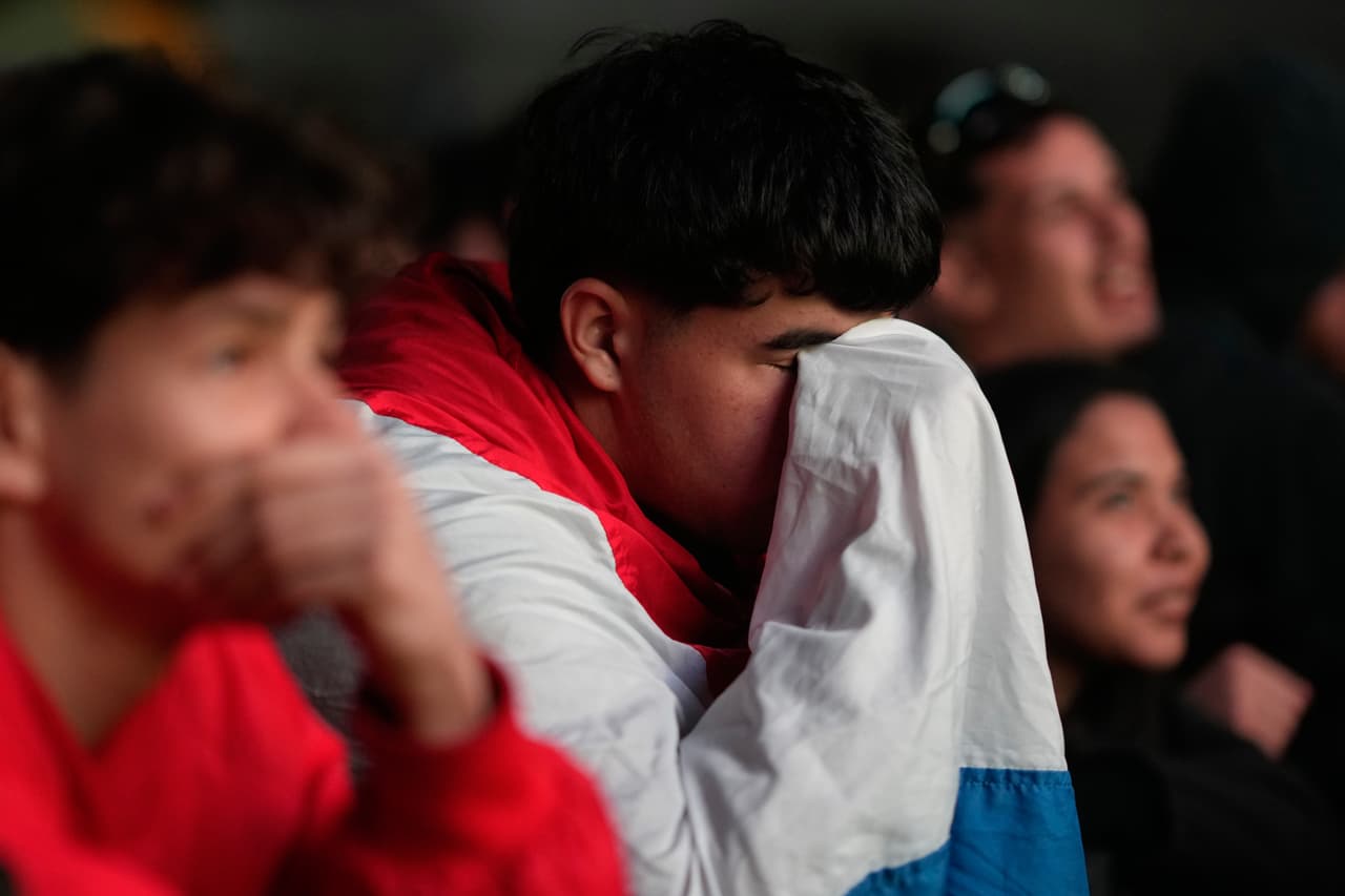 Aficionados paraguayos reaccionan mientras ven el partido en Asunción, Paraguay