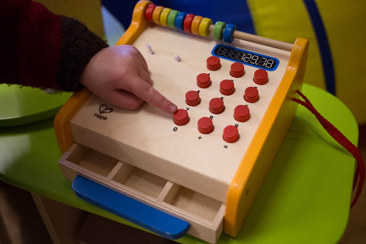 RADSTOCK, UNITED KINGDOM - JANUARY 06: A young boy plays with a toy cash till at a playgroup for pre-school aged children in Chilcompton near Radstock on January 6, 2015 in Somerset, England. Along with the health and the economy, education and childcare are to be key issues in the forthcoming election. (Photo by Matt Cardy/Getty Images)