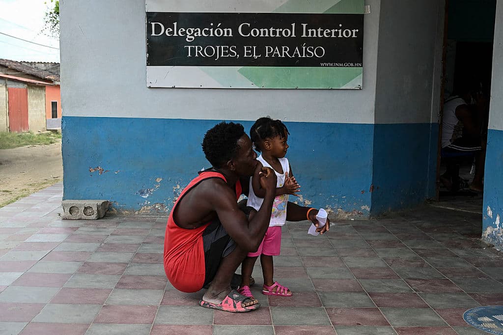 <b>Haití.</b> Un migrante haitiano y su hija en las afueras de una oficina de migración en una municipalidad hondureña a la espera de la aprobación para seguir su camino hacia Estados Unidos, donde aspiraban pedir asilo en abril de 2021. El vicealcalde de la municipalidad de Trojes, Dinora Sandoval, donde se encuentra el padre de la foto, dijo a la agencia AFP entonces que 
<b>un promedio de 400 personas procedentes de países africanos, haitianos y cubanos, pasan diariamente por esa localidad.</b> En los últimos dos años, los haitianos han sido la segunda población en solicitudes de refugio en México: sumaron 5,960 en 2020 y hasta mayo de 2021 llevan 7,135. Según la Comar, desde 2013 hasta ahora, más 4,400 casos de haitianos han sido resueltos, poco menos de la mitad de forma favorable. Eso los coloca como la quinta población de migrantes con más casos positivos resueltos, después de los hondureños, los salvadoreños, los venezolanos y los cubanos.