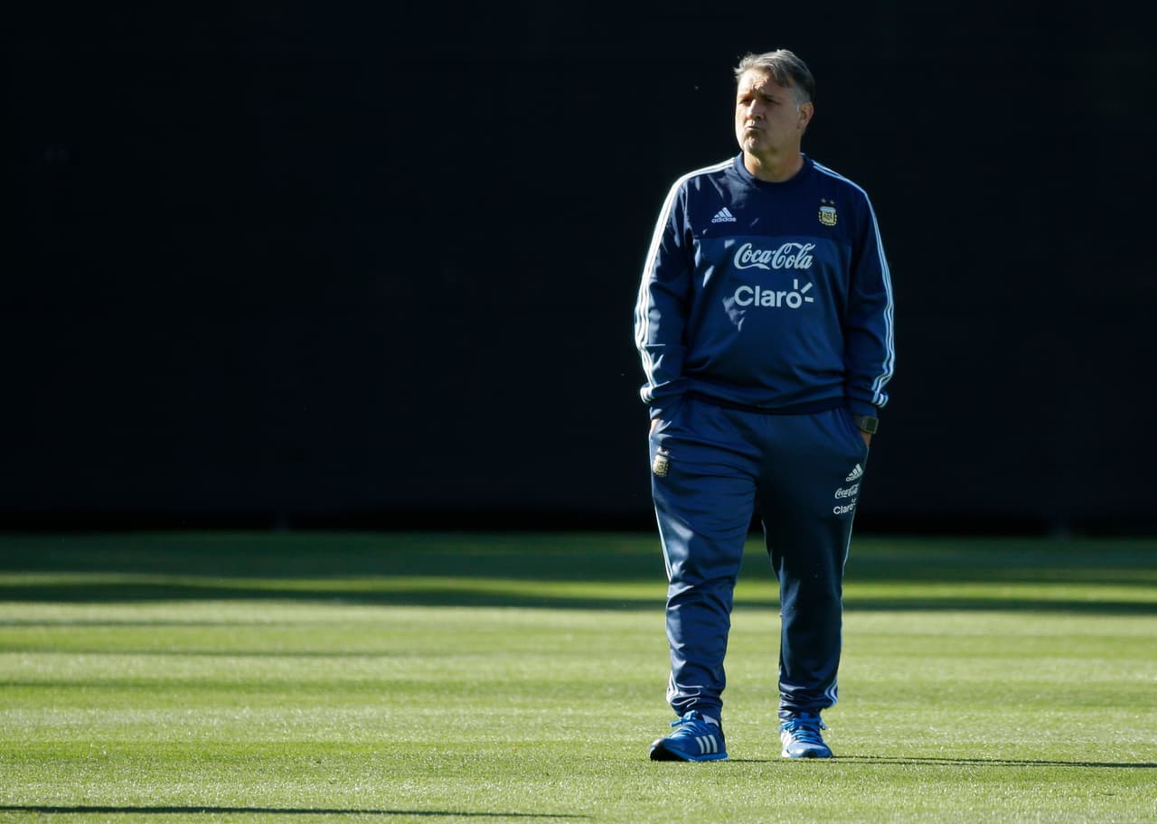 FILE - In this June 13, 2016 file photo, Argentina head coach Gerardo Martino stands on the pitch during practice, in Tukwila, Wash. With the start of the World Cup qualifiers over just two weeks away, Martino’s successor Edgardo Bauza is unable to sign his contract because Martino has yet to be paid his eight months of salary owed. (AP Photo/Ted S. Warren, File)