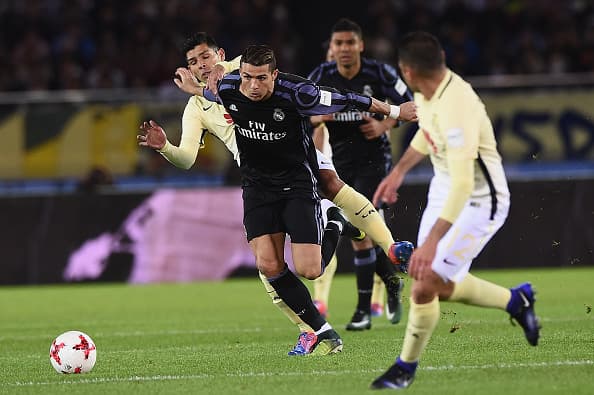 YOKOHAMA, JAPAN - DECEMBER 15: Cristiano Ronaldo of Real Madrid takes on the defence during the FIFA Club World Cup Japan semi-final match between Club America v Real Madrid at International Stadium Yokohama on December 15, 2016 in Yokohama, Japan. (Photo by Matt Roberts/Getty Images,)