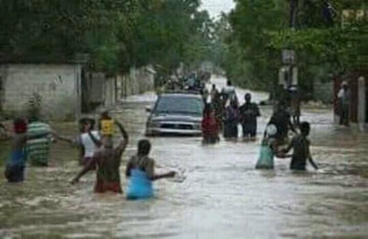 Residents waded through flooded streets in the southwestern city of Les Cayes