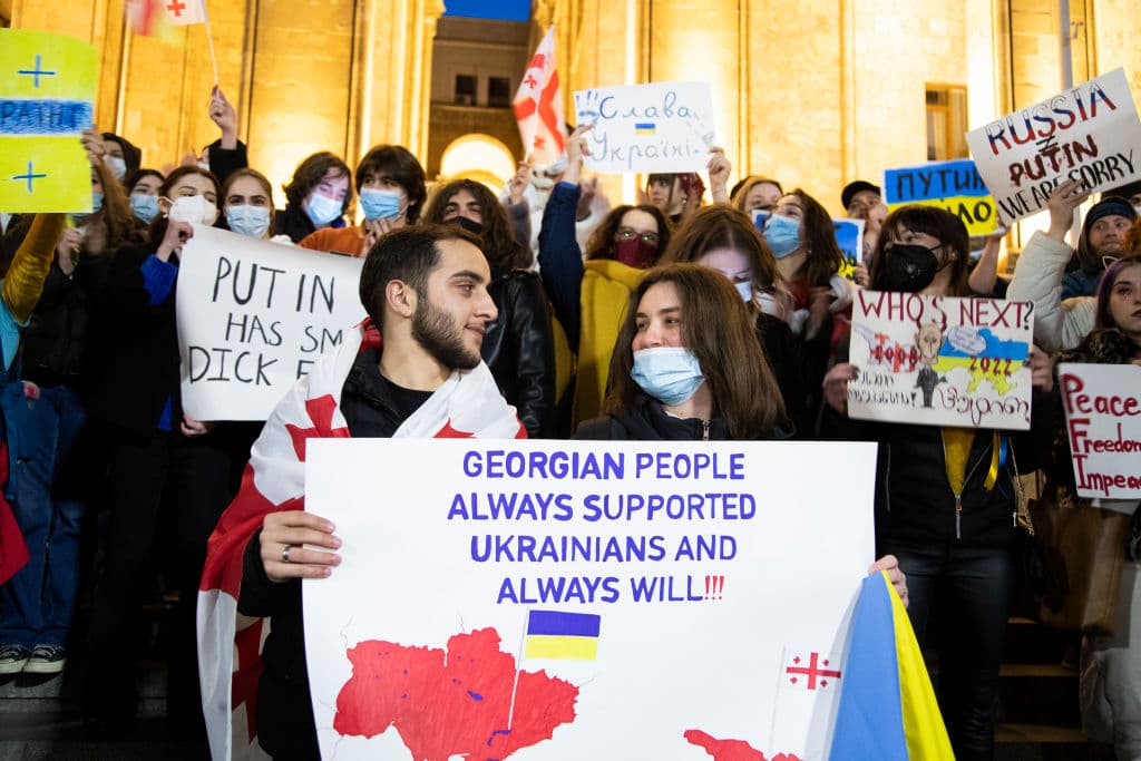 "La gente de Georgia siempre apoyará a los ucranianos", dice el letrero que sostienen dos manifestantes en Tbilisi, Georgia, este domingo.