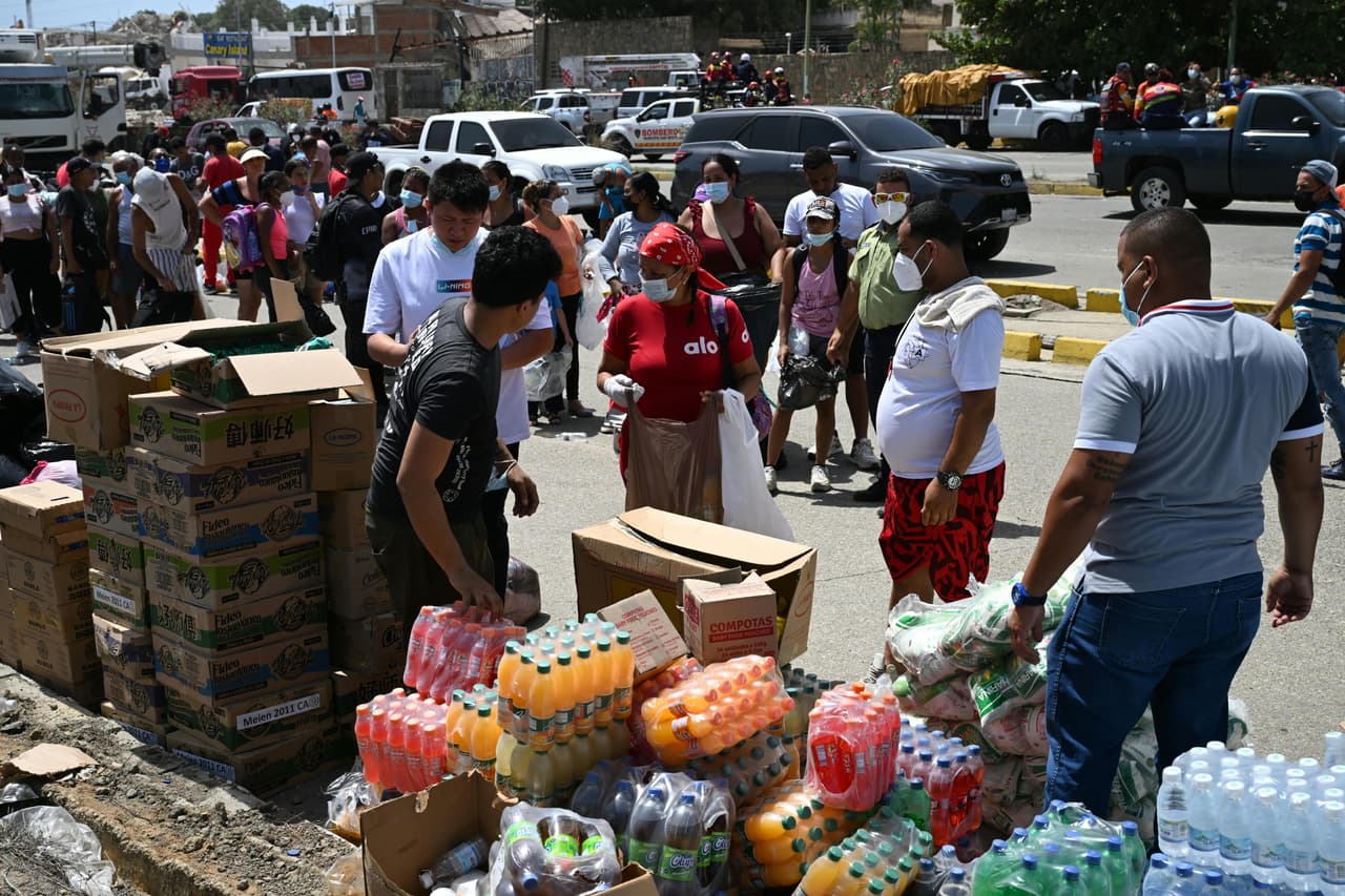 La gente hace fila para recibir alimentos y bebidas donados tras los dos terremotos que azotaron el país hace tres días en Caraballeda, Venezuela.