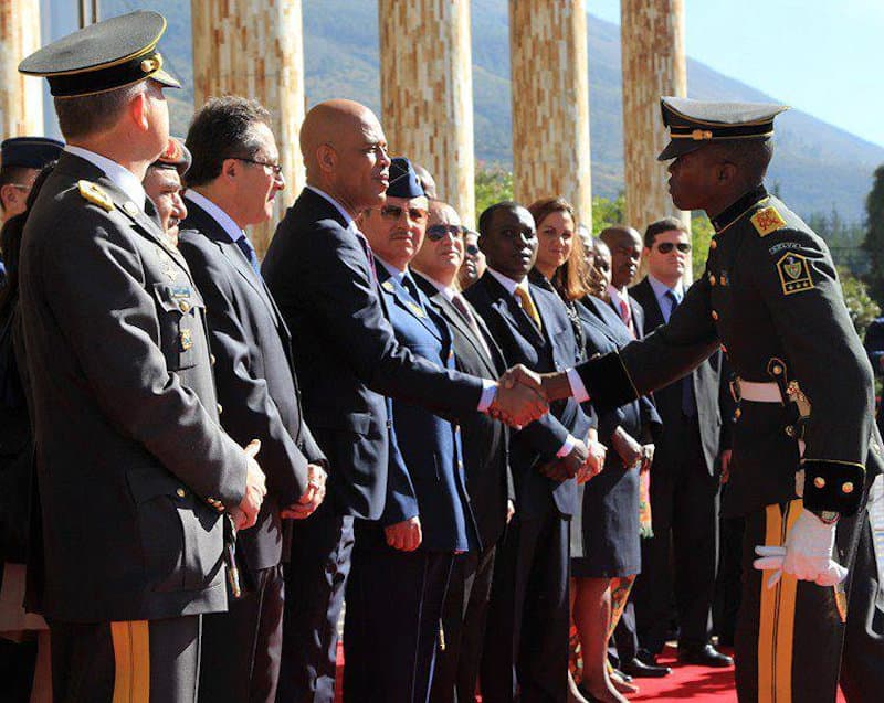 Cadet Dimitri Herard shaking the hand of Haitian president Michel Martelly during a visit to the Eloy Alfaro military academy in Ecuador in 2012.