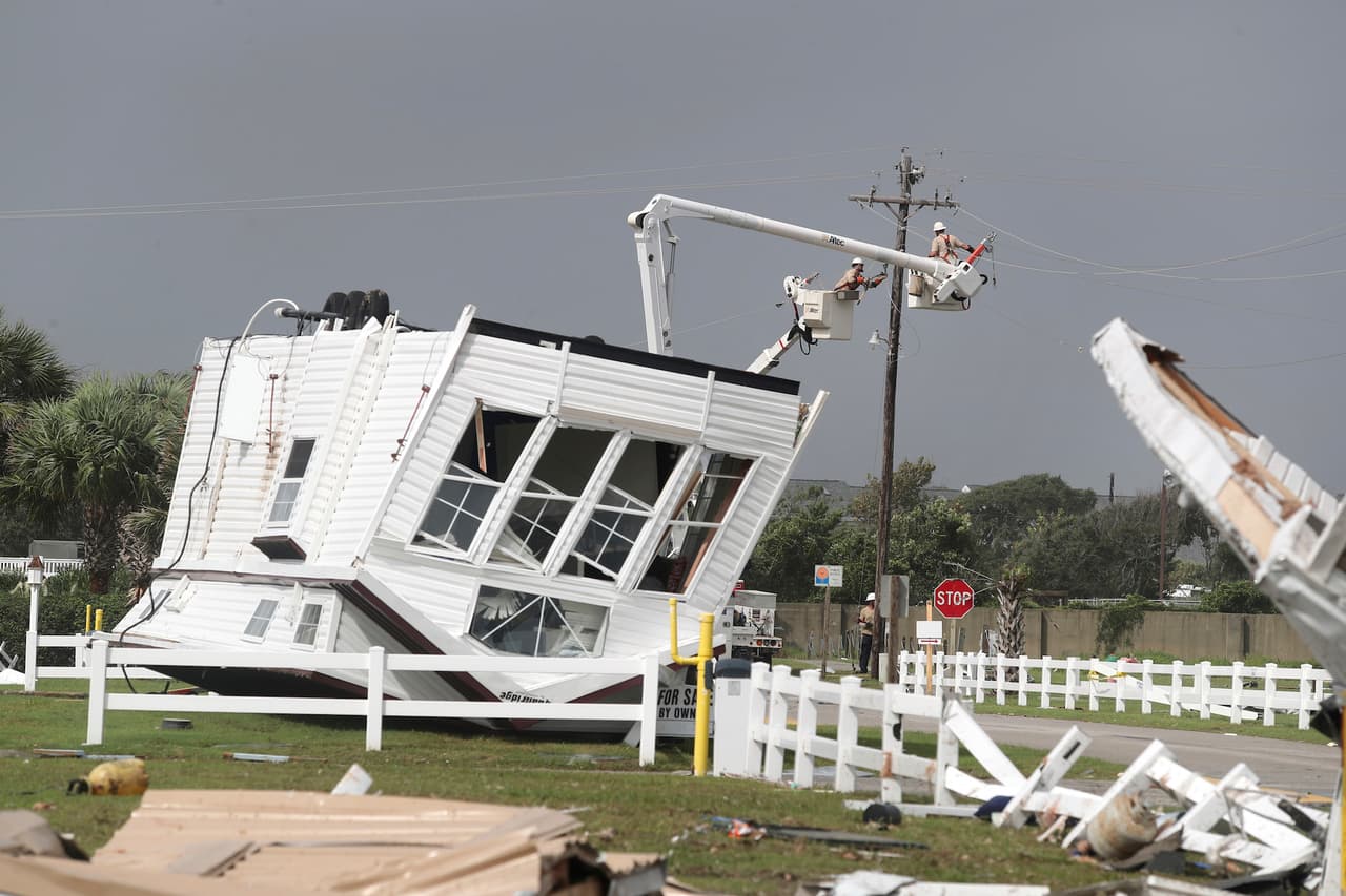 Power company linemen work to restore power after a tornado hit Emerald Isle N.C. as Hurricane Dorian moves up the East coast on Thursday, Sept. 5, 2018. (AP Photo/Tom Copeland)