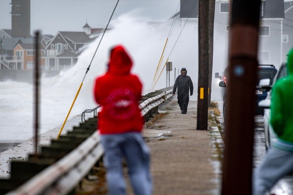 Varias personas caminan por la costa mientras las olas azotan la orilla durante la tormenta Nor’easter en Scituate, Massachusetts, el 26 de septiembre de 2026.