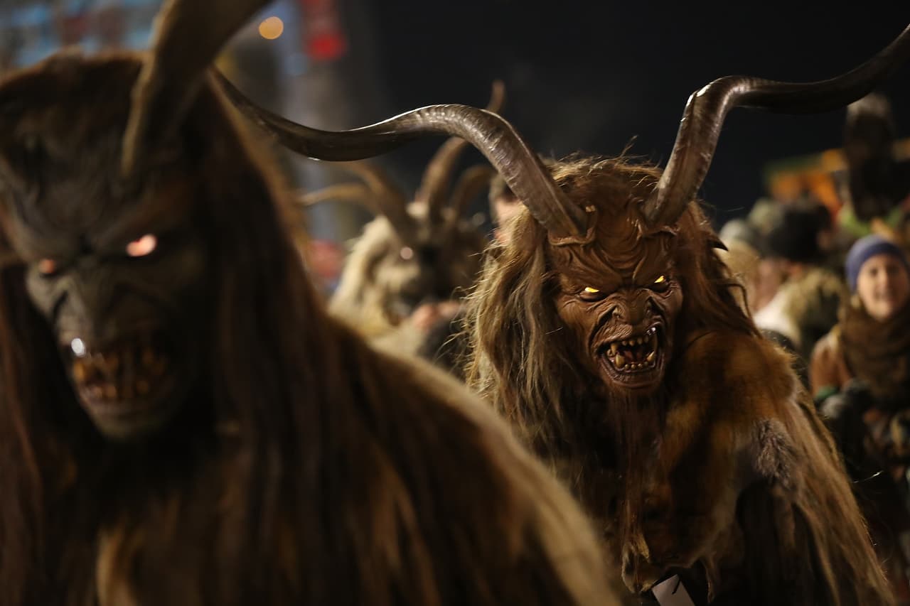 SANKT JOHANN IM PONGAU, AUSTRIA - DECEMBER 06: Men wearing horned, wooden masks and dressed as the Krampus creature prepare to participate in the annual Krampus parade on Saint Nicholas Day on December 6, 2017 in Sankt Johann im Pongau, Austria. Several hundred Krampus creatures from the region took part in this year's Sankt Johann parade. Krampus traditionally accompanies Saint Nicholas and angels in a house to house procession to reward children who have been good and warn those who have not, though in recent decades Krampus parades have become an intrinsic part of local folklore and take place throughout the end of November and into the first half of December in the alpine regions of Germany, Austria and Italy. Krampus usually wears large cowbells on his back that he rings by shaking his hips to ward off the evil spirits of winter. He also carries a switch made of branches or animal hair that he uses to whip bystanders. (Photo by Sean Gallup/Getty Images)