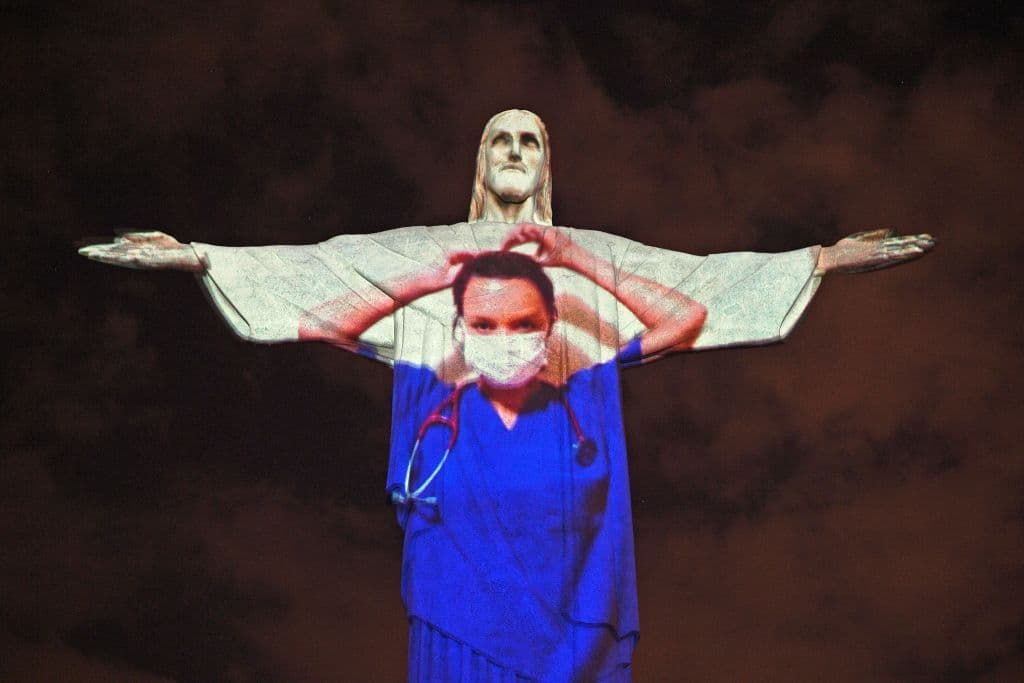 La imagend e una trabajadora médica proyectada en el Cristo Redentor de Río de Janeiro.