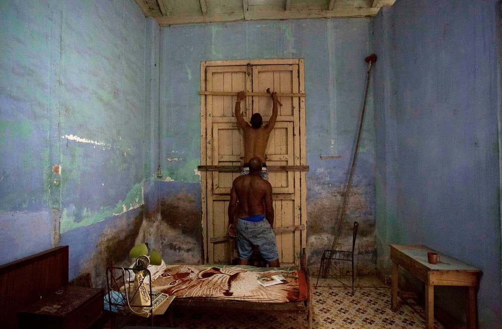 Men board up a door in preparation for Hurricane Irma in Caibarien, Cuba, Friday, Sept. 8, 2017. Cuba evacuated tourists from beachside resorts after Hurricane Irma left thousands homeless on a devastated string of Caribbean islands and spun toward Florida for what could be a catastrophic blow this weekend. (AP Photo/Desmond Boylan)