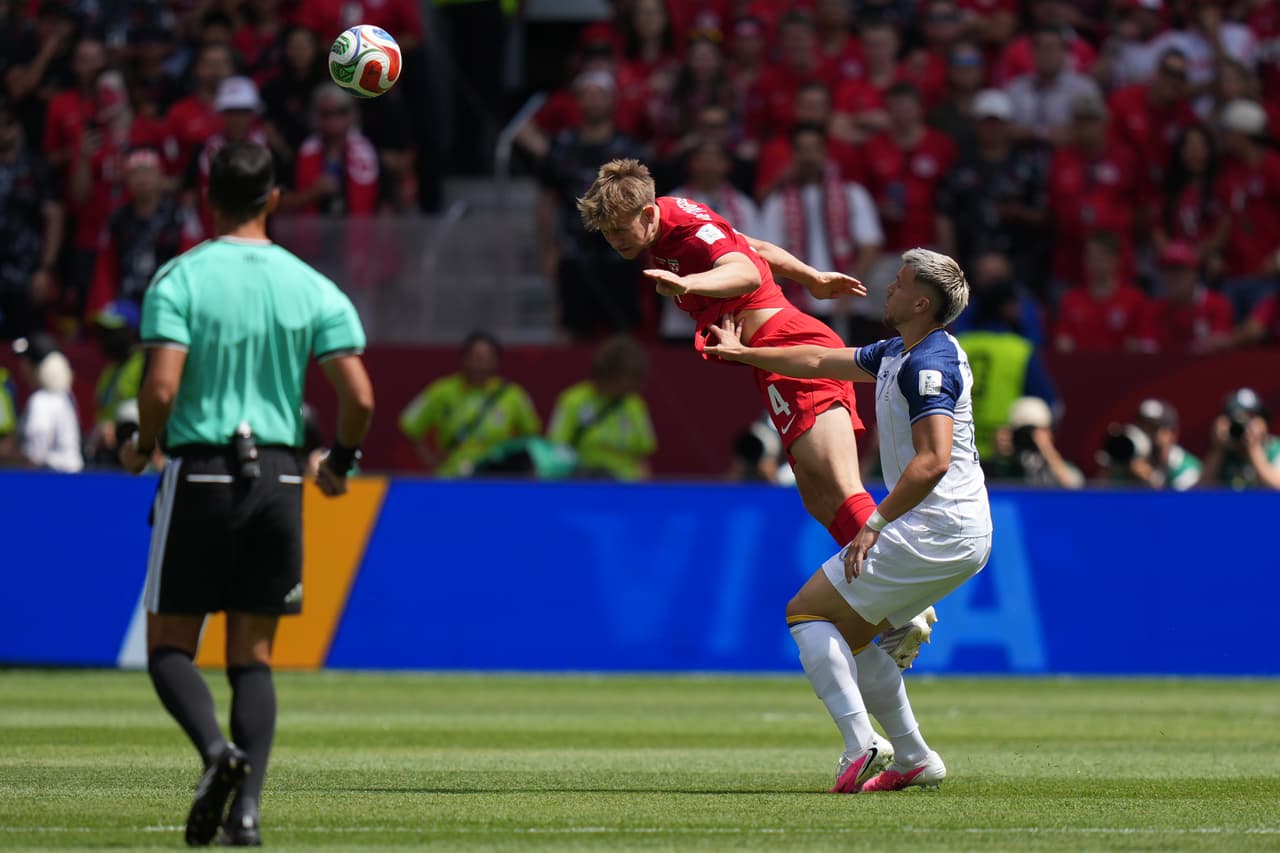 Canada's Luc de Fougerolles, left, heads the ball under pressure from Bosnia's Tarik Muharemovic during the World Cup Group B soccer match between Canada and Bosnia in Toronto, Friday, June 12, 2026. (AP Photo/Stephanie Scarbrough)