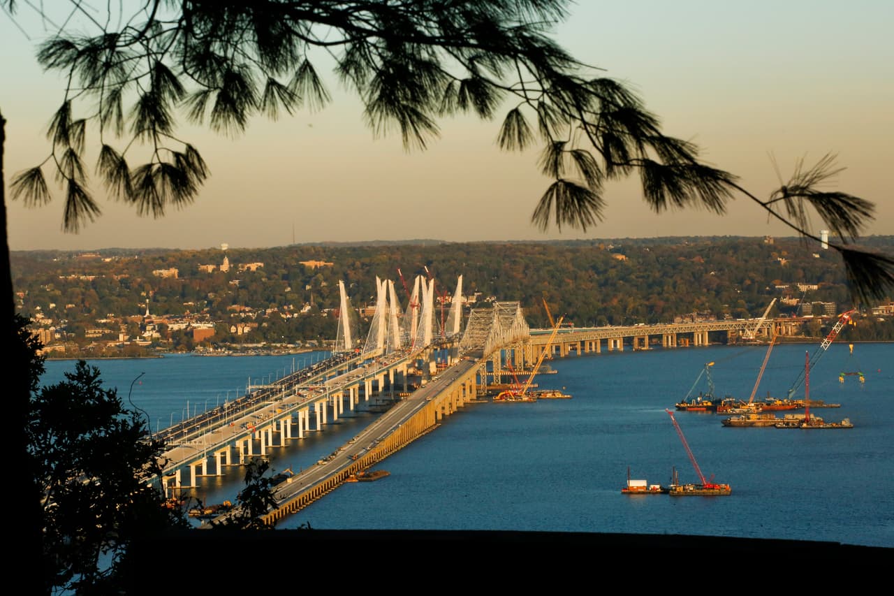 SOUTH NYACK, NY - OCTOBER 27: Cranes are seen near the new and the old Tappan Zee Bridge on October 27, 2017 in South Nyack, New York. . Tolls on the new Tappan Zee Bridge may have to hit the $10 mark to pay for the $4 billion construction costs, according to a report from a non-partisan watchdog group. (Photo by VIEWpress/Corbis via Getty Images)
