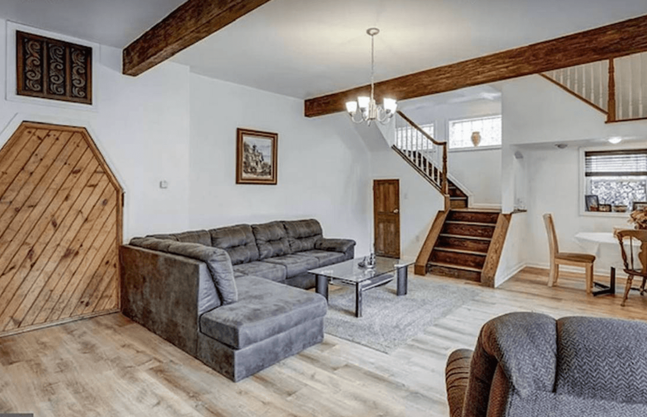 La sala de estar de la casa en
<b>434 E. Market St</b>. tiene una entrada de madera a la cueva en el sótano.
<br>