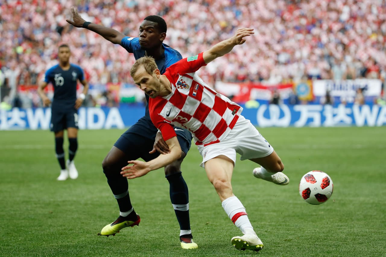 France's midfielder Paul Pogba and Croatia's defender Ivan Strinic vie for the ball during the Russia 2018 World Cup final football match between France and Croatia at the Luzhniki Stadium in Moscow on July 15, 2018. (Photo by Odd ANDERSEN / AFP) / RESTRICTED TO EDITORIAL USE - NO MOBILE PUSH ALERTS/DOWNLOADS (Photo credit should read ODD ANDERSEN/AFP/Getty Images)