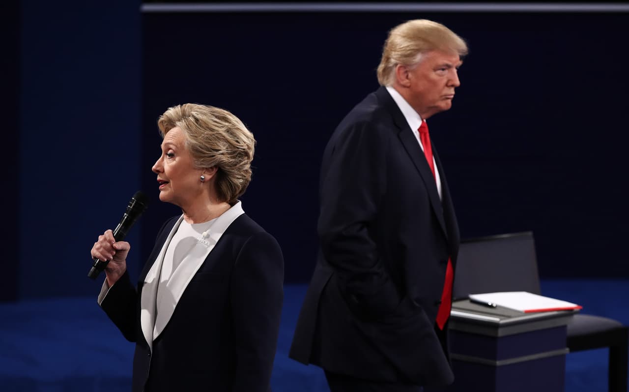 ST LOUIS, MO - OCTOBER 09: Democratic presidential nominee former Secretary of State Hillary Clinton (L) speaks as Republican presidential nominee Donald Trump listens during the town hall debate at Washington University on October 9, 2016 in St Louis, Missouri. This is the second of three presidential debates scheduled prior to the November 8th election. (Photo by Win McNamee/Getty Images)