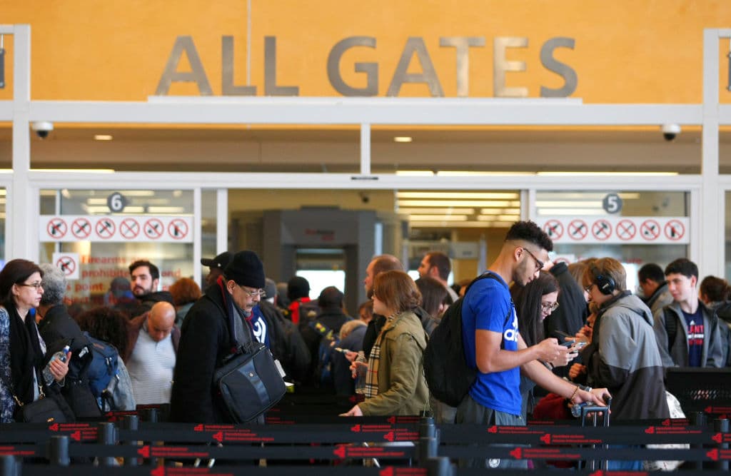 Travelers move through waiting lines at the international counter the day following a major power outage caused by a fire at Hartsfield-Jackson Atlanta International Airport in Atlanta, Georgia, December 18, 2017. The world's busiest airport in the US city of Atlanta was slowly resuming normal operations Monday after a power cut stranded thousands of passengers and unleashed a storm of criticism. / AFP PHOTO / TAMI CHAPPELL (Photo credit should read TAMI CHAPPELL/AFP/Getty Images)