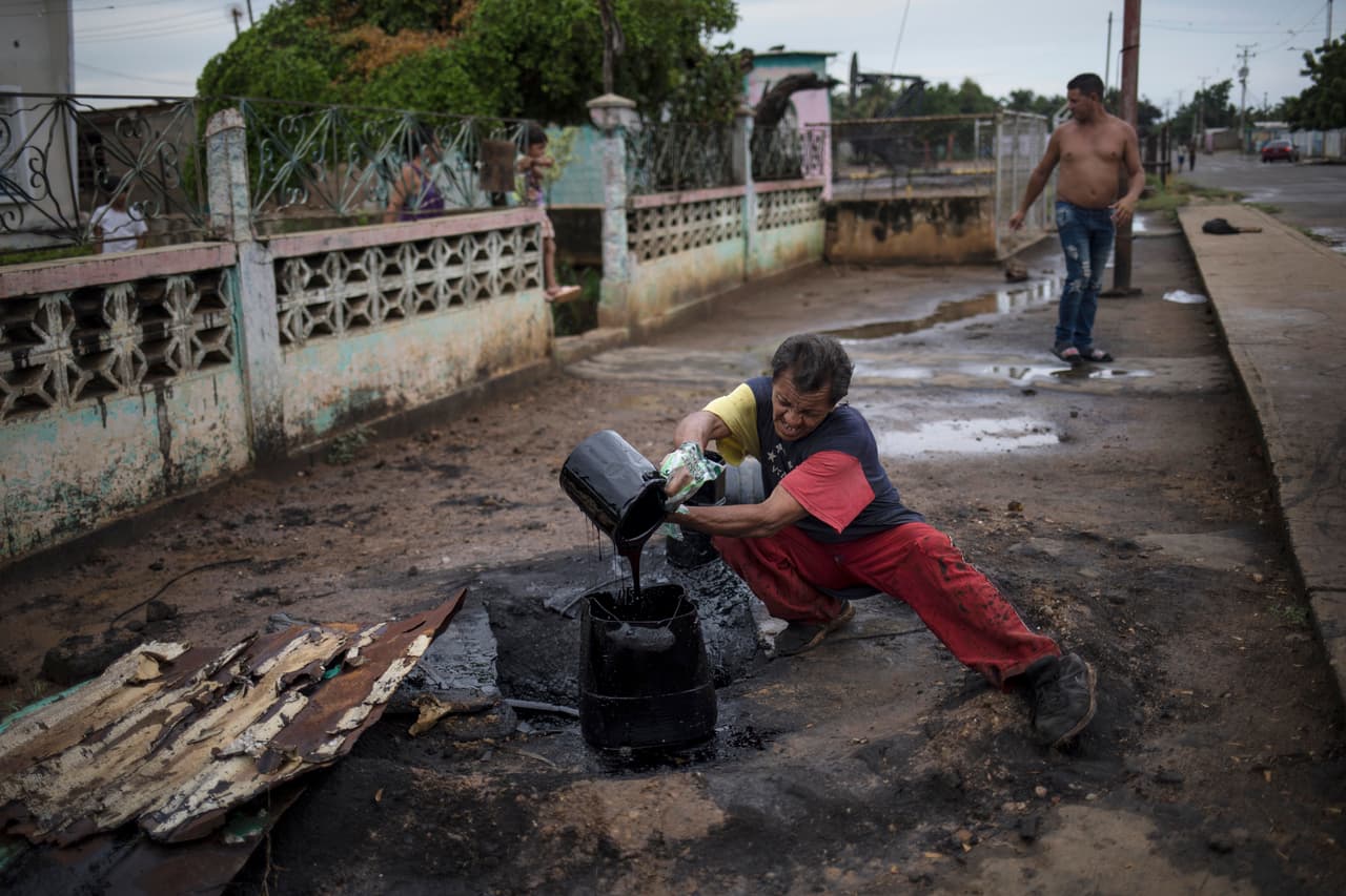 Cornelis Elferink, profesor de farmacología y toxicología de la Universidad de Texas en Galveston, dijo que el ingerir ocasionalmente cangrejo recogido de aguas contaminadas probablemente no implica un riesgo a la salud, pero cree que los que
<a href="https://www.univision.com/noticias/america-latina/ni-los-muertos-esquivan-la-miseria-en-maracaibo-la-meca-petrolera-hoy-destruida-por-la-crisis-en-venezuela-fotos-fotos">sí están en grave riesgo son los pescadores, que deben trabajar en un ambiente contaminado día tras día</a>. En la fotogra´fia José Lugano, mientras recoge el petróleo que se escapa cerca de las tuberías que llevan gas a su cocina en Cabimas.