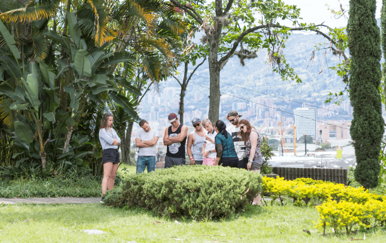 Turistas visitando la tumba de pablo Escobar como parte de un narcotour.