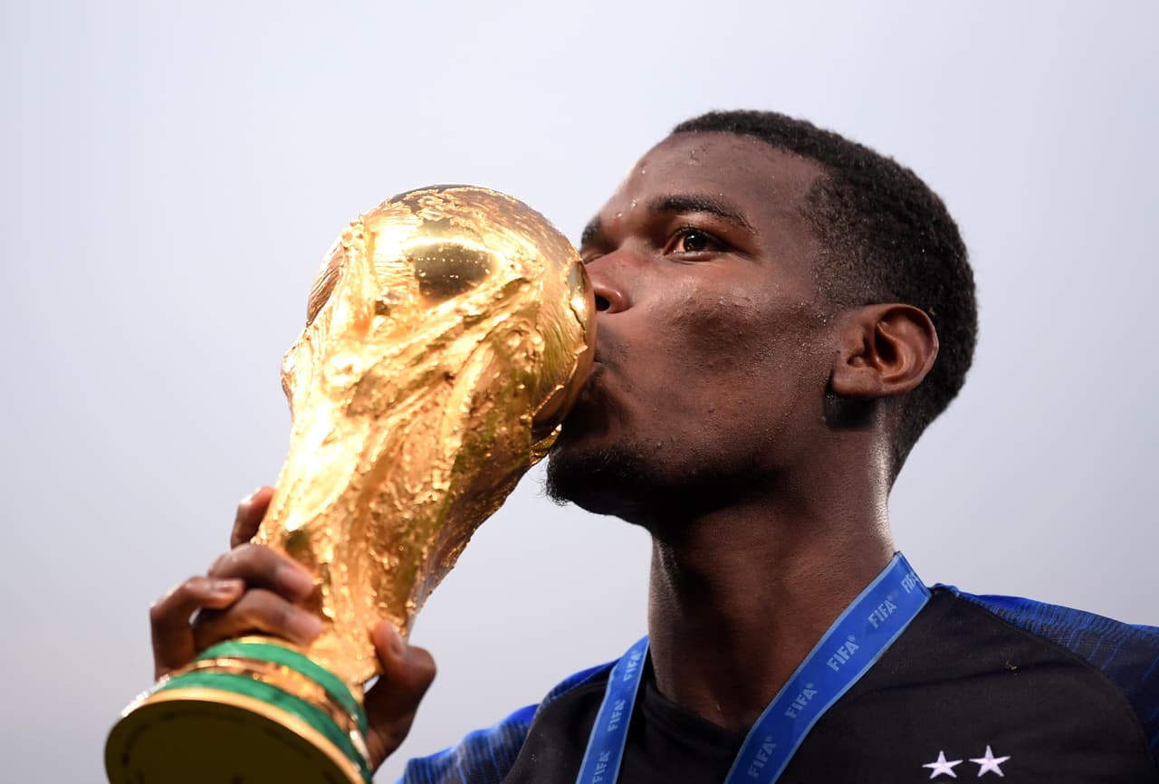 MOSCOW, RUSSIA - JULY 15: Paul Pogba of France celebrates victory by kissing the World Cup trophy following the 2018 FIFA World Cup Final between France and Croatia at Luzhniki Stadium on July 15, 2018 in Moscow, Russia. (Photo by Laurence Griffiths/Getty Images)