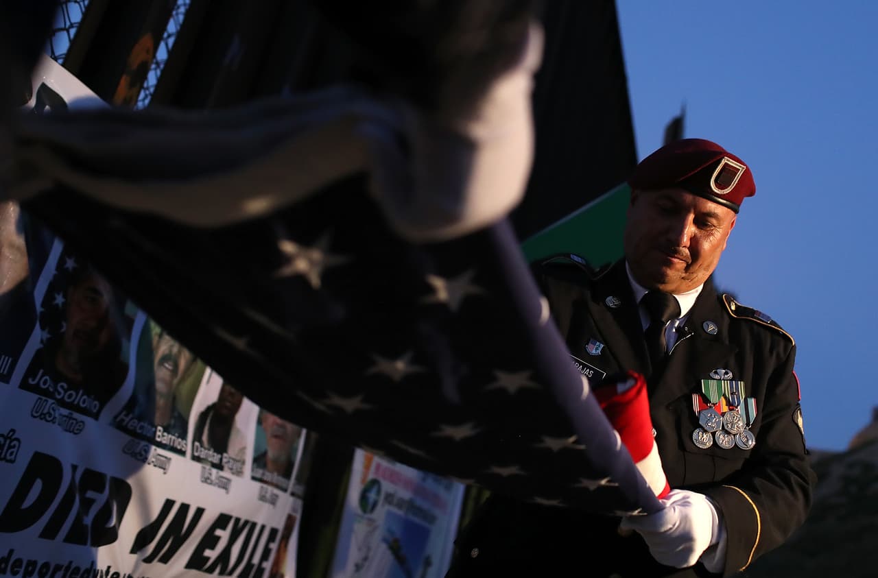 TIJUANA, MEXICO - JULY 04: Deported U.S. Army veteran Hector Barajas folds an American flag during a Fourth of July gathering on the beach next to the US-Mexican border fence at Playas de Tijuana on July 4, 2017 in Tijuana, Mexico. The Deported Veterans Support House, also known as "The Bunker" was founded by deported U.S. Army veteran Hector Barajas to support deported veterans by offering food, shelter, clothing as well as advocating for political legislation that would prohibit future deportations of veterans. There are an estimated 11,000 non-citizens serving in the U.S. military and most will be naturalized during or following their service. Those who leave the military early or who are convicted of a crime after serving can be deported. (Photo by Justin Sullivan/Getty Images)