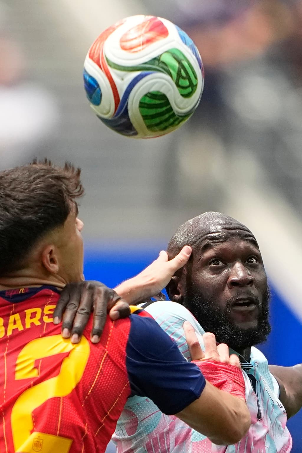 Spain's Pau Cubarsi (22) battles for the ball with Belgium's Romelu Lukaku (9) during the World Cup quarterfinal soccer match between Spain and Belgium in Inglewood, Calif., near Los Angeles, Friday, July 10, 2026. (AP Photo/Lindsey Wasson)