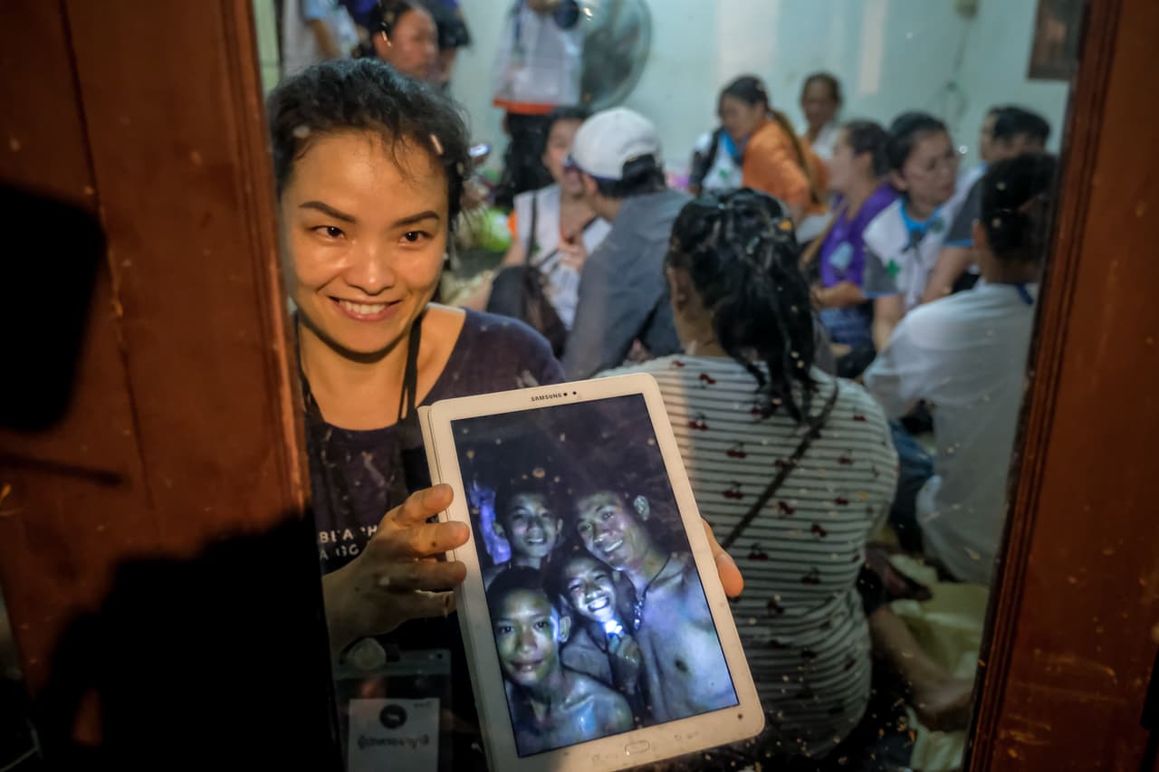 Los familiares de los jóvenes, reunidos cerca de una de las entradas de la cueva celebran al ver las fotografías de los chicos aún con vida. Bucear en una caverna, con partes angostas en subidas y bajadas es muy riesgoso para los que no son buzos especializados.