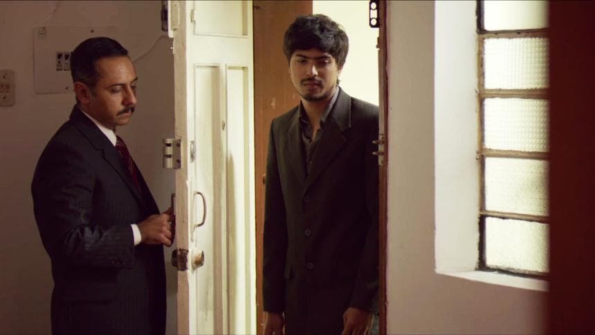 A man dressed in a suit knocks at the door.