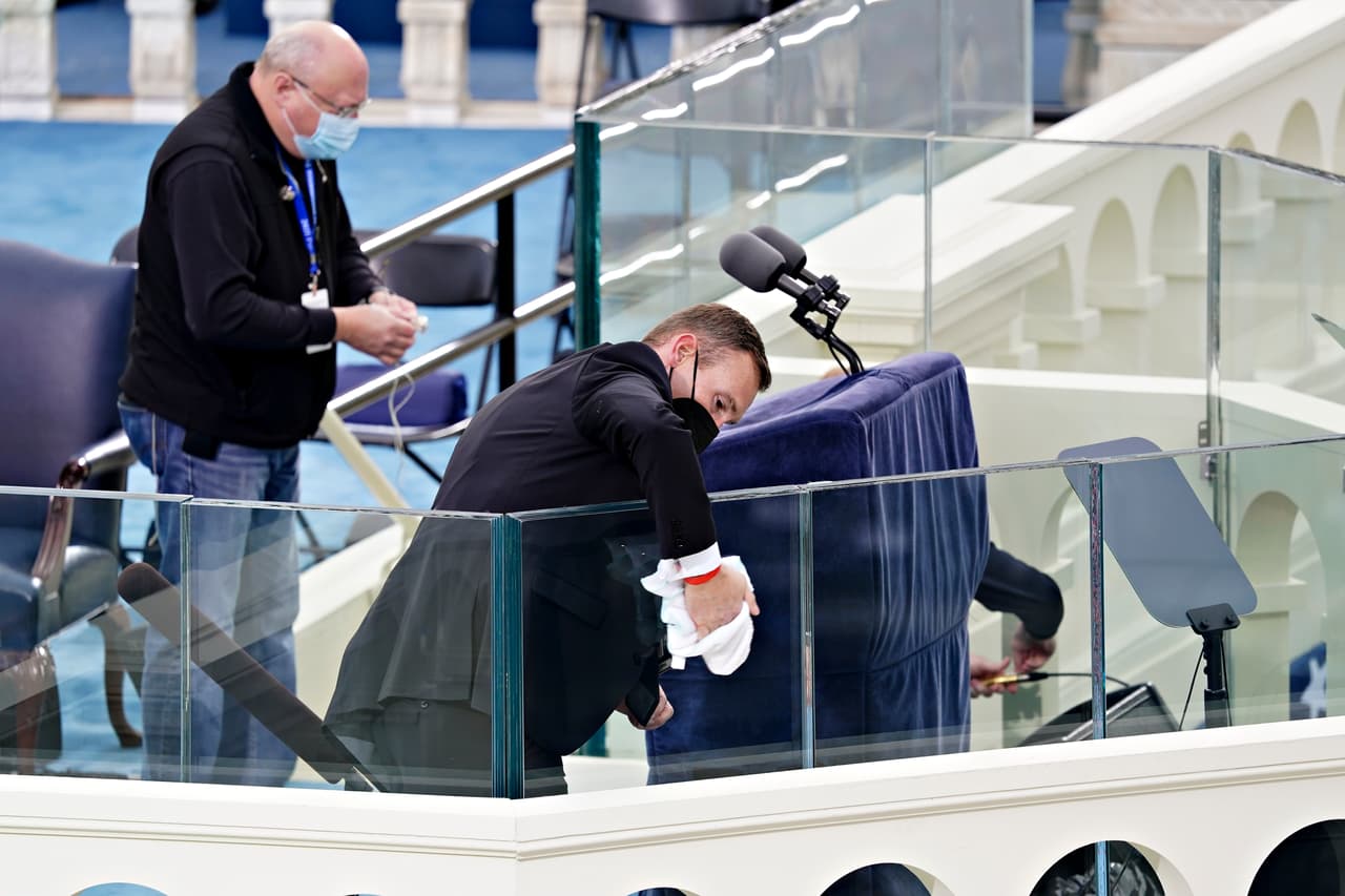 Trabajadores dan los últimos toques al lugar donde serán juramentados Biden y Harris.