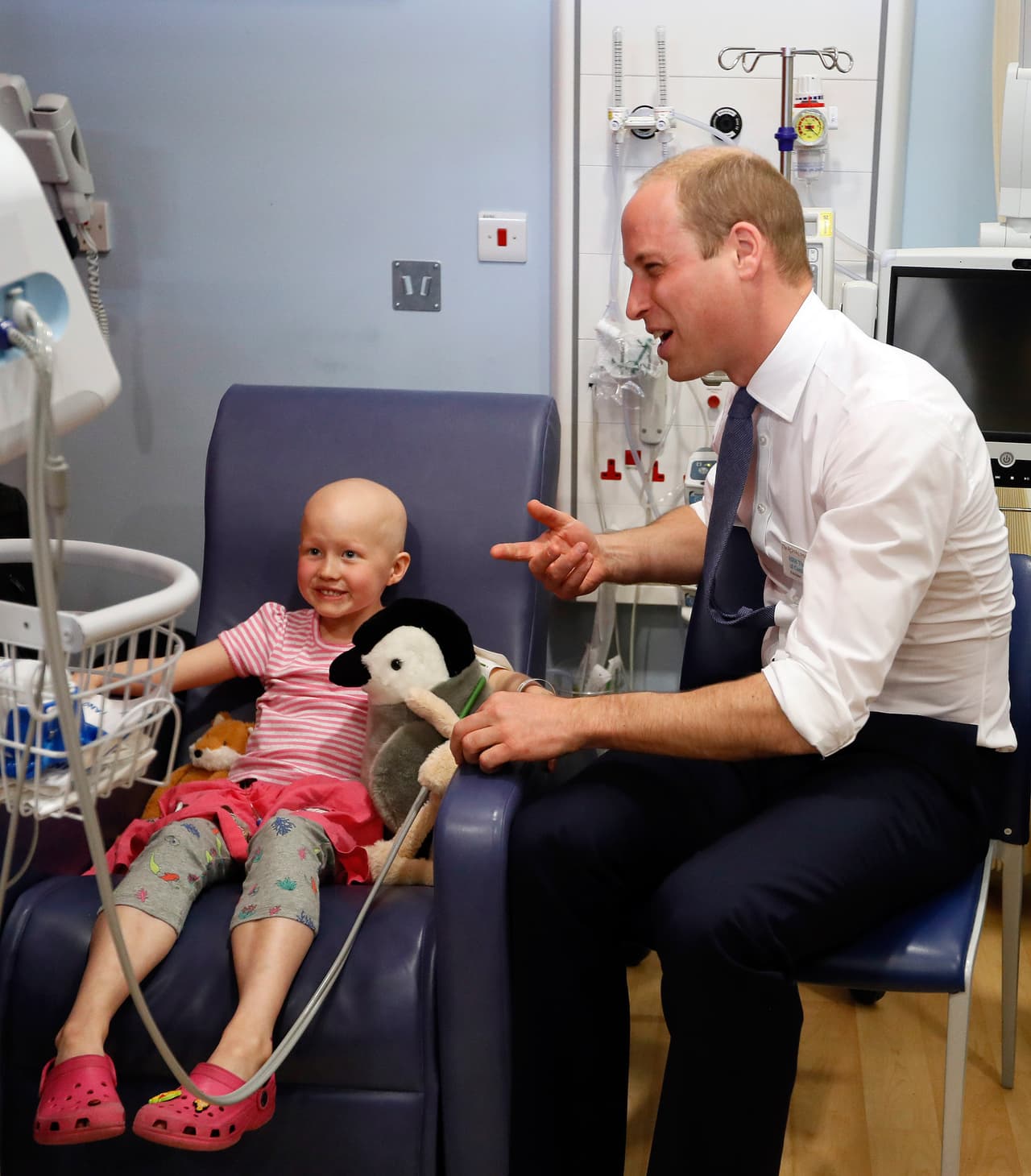 LONDON, UNITED KINGDOM - MAY 16: Prince William, Duke of Cambridge talks with patient Daisy Wood, 6, during a visit to the Royal Marsden hospital on May 16, 2017 in Sutton, England. The Duke of Cambridge, President of the Royal Marsden NHS Foundation Trust, visited the hospital's facilities in Sutton. During the visit, which marks 10 years since His Royal Highness became President of the centre, The Duke accompanied staff as they went about their daily activities in treating and caring for patients. (Photo by Kirsty Wigglesworth - WPA Pool/Getty Images)