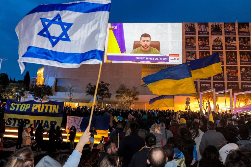 Manifestantes contra la guerra en Tel Aviv ven el discurso de Zelensky en vivo este domingo.
