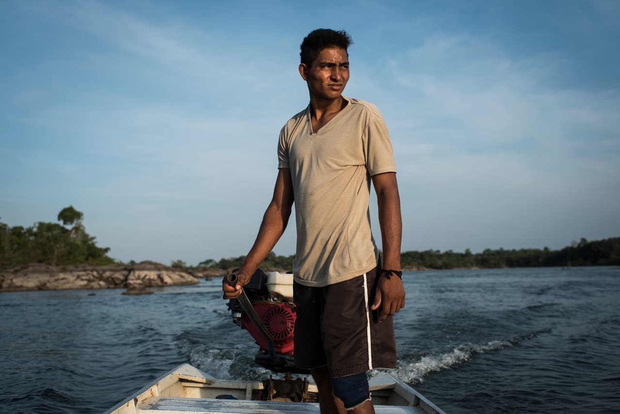 Henriques P. Morois, 20, heads out to fish on the Xingu River. Fishing has sustained the Juruna of the Volta Grande for decades, both for sustenance and for commerce. Since the completion of the Belo Monte Dam they have seen fish populations plummet and one ornamental fish they once caught and sold for good money, the Zebra Pleco, which only lives on this one stretch of river, is now endangered and prohibited to fish. Dec 8, 2016.