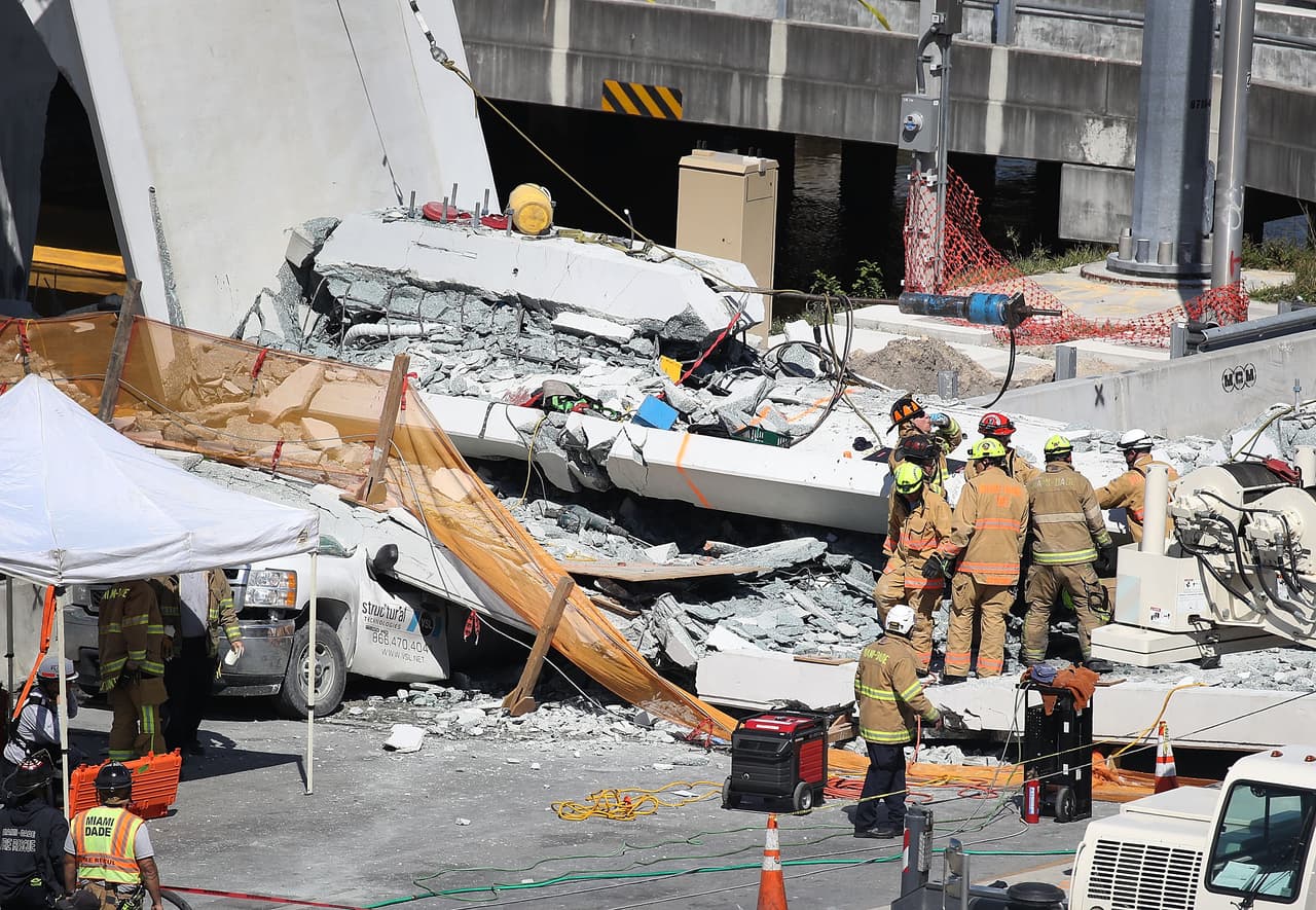 MIAMI, FL - MARCH 15: Miami-Dade Fire Rescue Department personel and other rescue units work at the scene where a pedestrian bridge collapsed a few days after it was built over southwest 8th street allowing people to bypass the busy street to reach Florida International University on March 15, 2018 in Miami, Florida. Reports indicate that there are an unknown number of fatalities as a result of the collapse, which crushed at least five cars. (Photo by Joe Raedle/Getty Images)