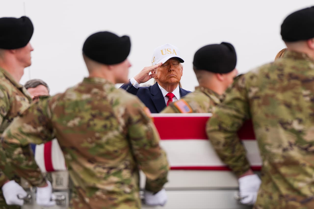 FILE - President Donald Trump salutes as an Army carry team moves a flag-draped transfer case with the remains of Sgt. Declan Coady, 20, of West Des Moines, Iowa, who was killed in a drone strike at a command center in Kuwait after the U.S. and Israel launched their military campaign against Iran, during a casualty return, March 7, 2026, at Dover Air Force Base, Del. (AP Photo/Julia Demaree Nikhinson, File)