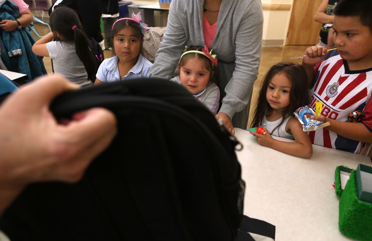 SAN FRANCISCO - AUGUST 27: Children look at a backpack that is being offered during a backpack giveaway at St. Anthony Foundation August 27, 2009 in San Francisco, California. St. Anthony Foundation gave away hundreds of backpacks filled with back-to-school supplies to needy children in San Francisco's Tenderloin neighborhood. (Photo by Justin Sullivan/Getty Images)