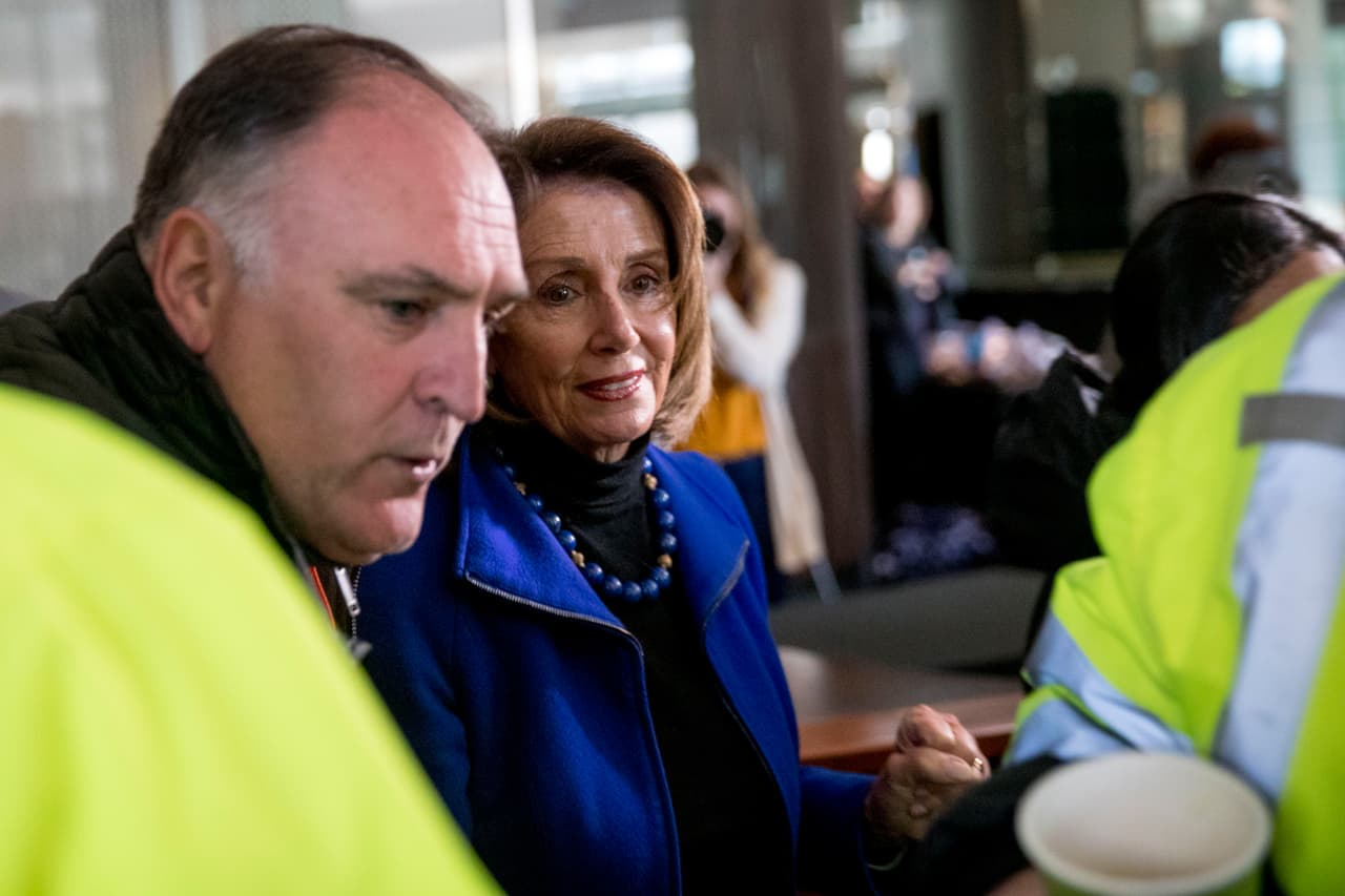 Chef Jose Andres, left, gives House Speaker Nancy Pelosi of Calif., center, a tour of a resource center set up to give out food and supplies which is part of the World Central Kitchen, the not-for-profit organization started by Chef Jose Andres, Tuesday, Jan. 22, 2019, in Washington. The organization devoted to providing meals in the wake of natural disasters, has set up a distribution center just blocks from the U.S. Capitol building to assist those affected by the government shutdown. (AP Photo/Andrew Harnik)
