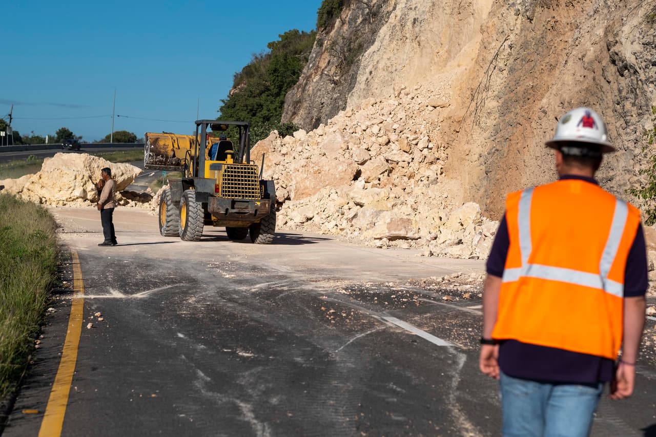 Los constantes movimientos mantienen en alerta a los puertorriqueños. En la fotografía, trabajadores despejan una vía afectada por los deslizamientos de tierra provocados por el temblor.