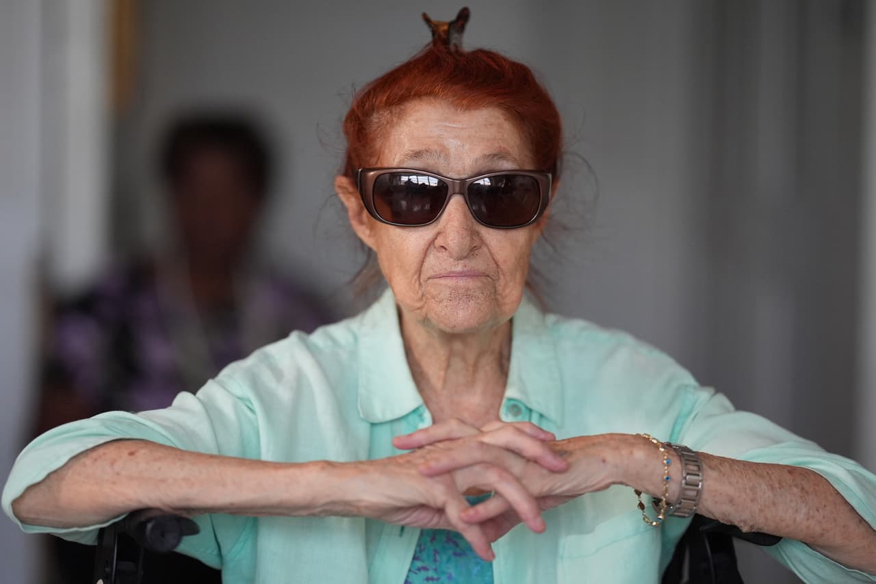 Anna Fischbein habla sobre la pérdida de una querida trabajadora de atención médica a domicilio haitiana cuyo estatus de protección temporal expiró esta semana, mientras otra trabajadora de la salud con ciudadanía estadounidense espera para llevarla a una cita médica, durante una entrevista en su apartamento, el jueves 30 de julio de 2026, en Sunny Isles Beach, Florida.