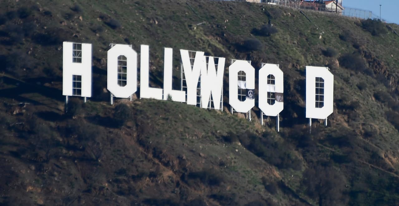 The famous Hollywood sign reads "Hollyweed" after it was vandalized, January 1, 2017. Police said unidentified thrill-seekers had climbed up and arranged tarps over the two letter "O's" to make them look like "E's," CBS affiliate KCAL reported. Each letter is 45 feet (13.7 meters) high, so the feat would have required not just bravado but considerable athleticism. / AFP / Gene Blevins (Photo credit should read GENE BLEVINS/AFP/Getty Images)
