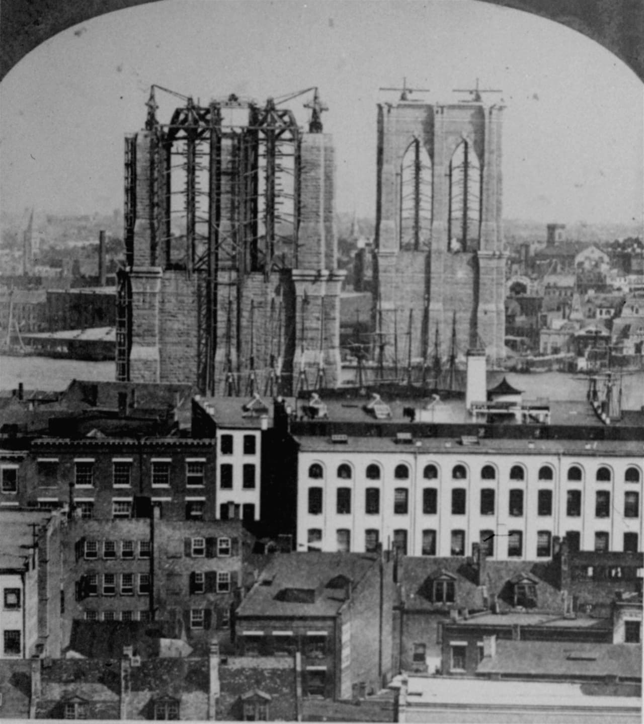 Los pilares del puente en plena construcción en 1876, en una vista desde Brooklyn hacia Manhattan. La enorme distancia entre los pilares, casi 16,000 pies, fue un reto para la ingeniería de la época.