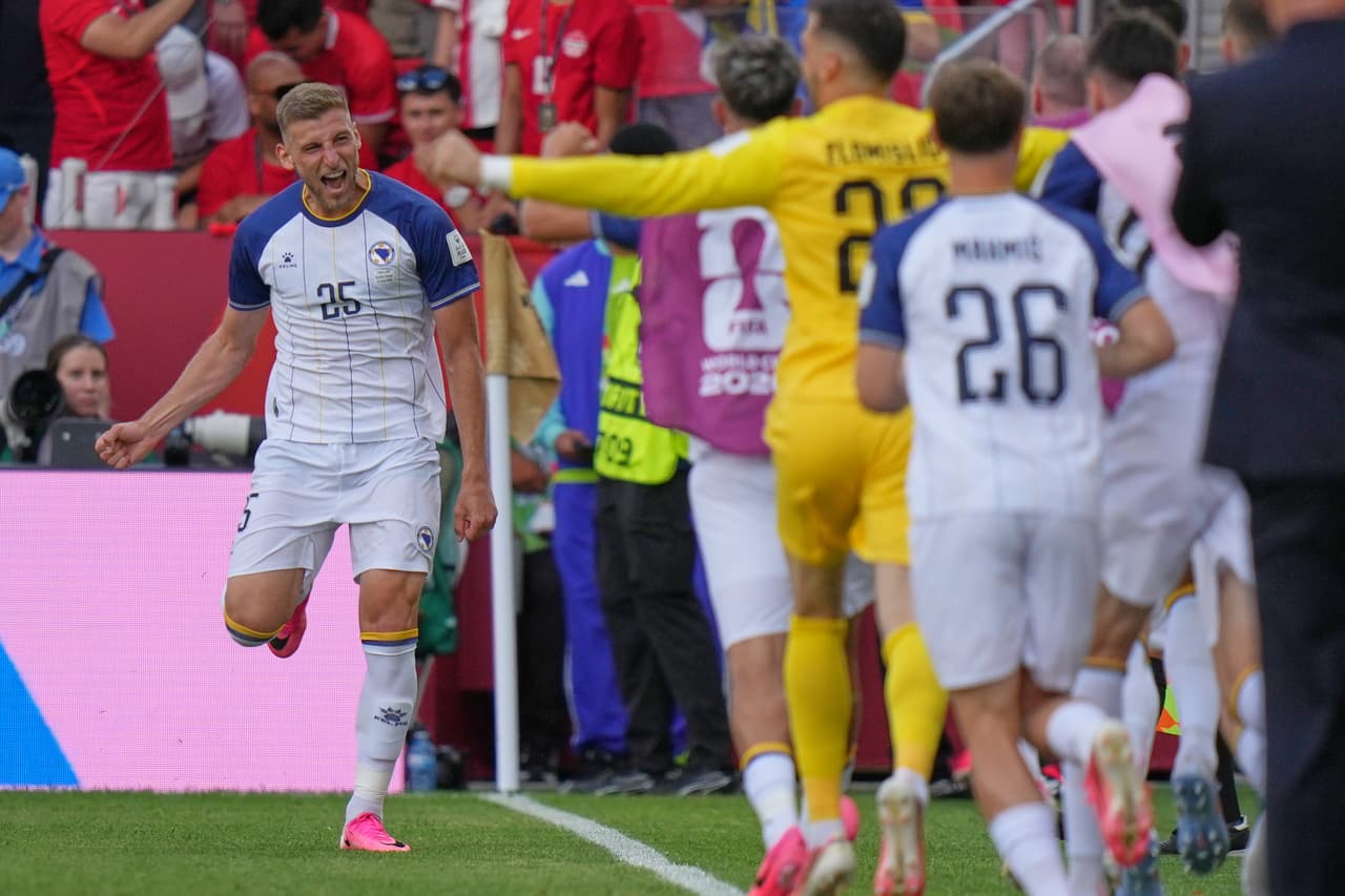 Bosnia's Jovo Lukic, left, celebrates after he scores the opening goal during the World Cup Group B soccer match between Canada and Bosnia in Toronto, Friday, June 12, 2026. (AP Photo/Stephanie Scarbrough)