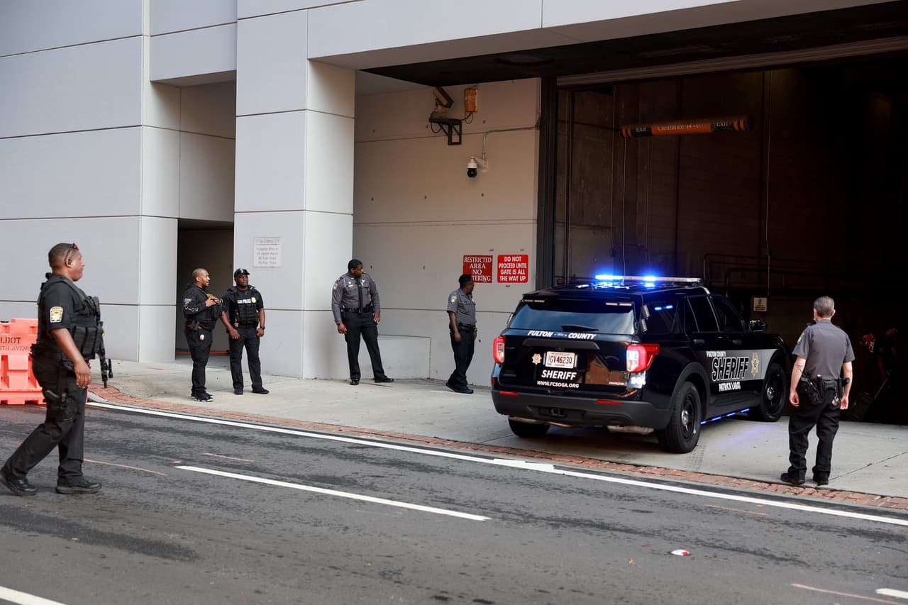 ATLANTA, GEORGIA - AUGUST 07: Fulton County Sheriff officers stand near a vehicle entranceway to the Fulton County Courthouse on August 07, 2023 in Atlanta, Georgia. The courthouse has more security in place as Fulton County District Attorney Fani Willis is expected to make an announcement soon about a possible grand jury indictment in her investigation into former President Donald Trump and his Republican allies alleged attempt to overturn the 2020 election in the state. (Photo by Joe Raedle/Getty Images)