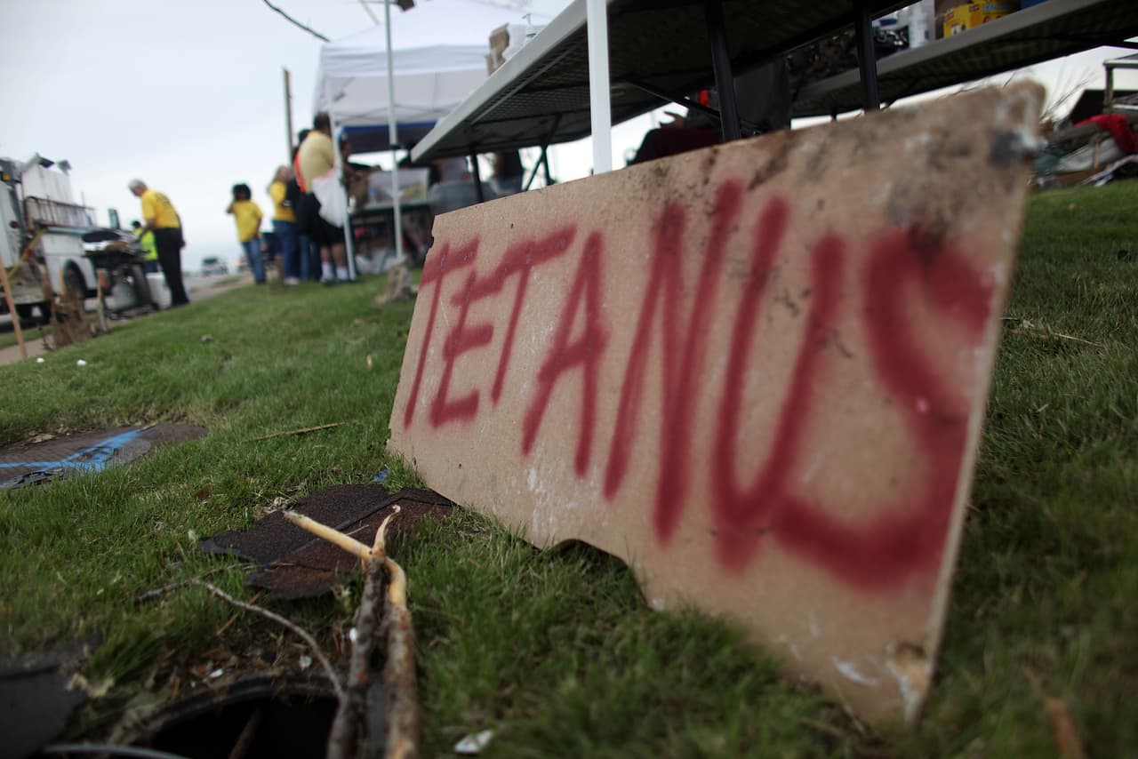 JOPLIN, MO - MAY 25: Free tetanus shots are available at a volunteer tent after a massive tornado passed through the town killing at least 123 people on May 25, 2011 in Joplin, Missouri. Authorities were prepared to find more bodies in the town of 50,000 people. (Photo by Mario Tama/Getty Images)