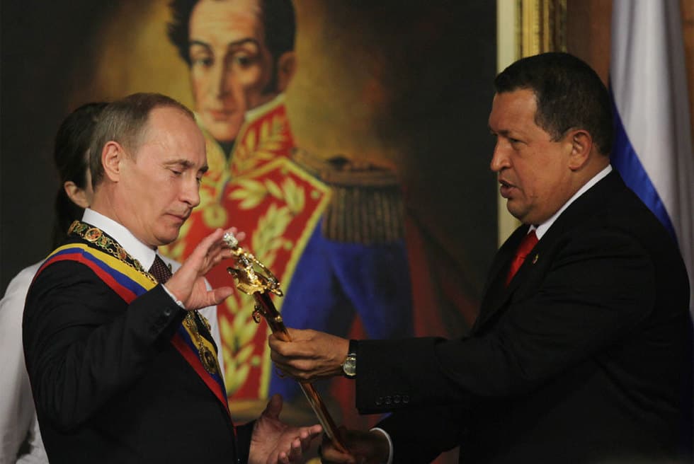 Hugo Chavez offers a ceremonial sword to Vladimir Putin during the Russian leader's official visit to Venezuela, April 2, 2010.