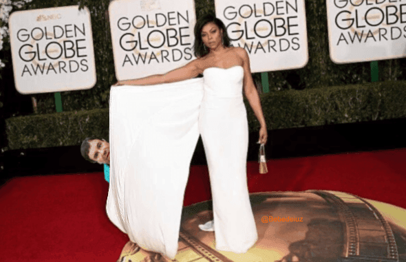 Ocultándose tras el vestido de Taraji P. Henson.