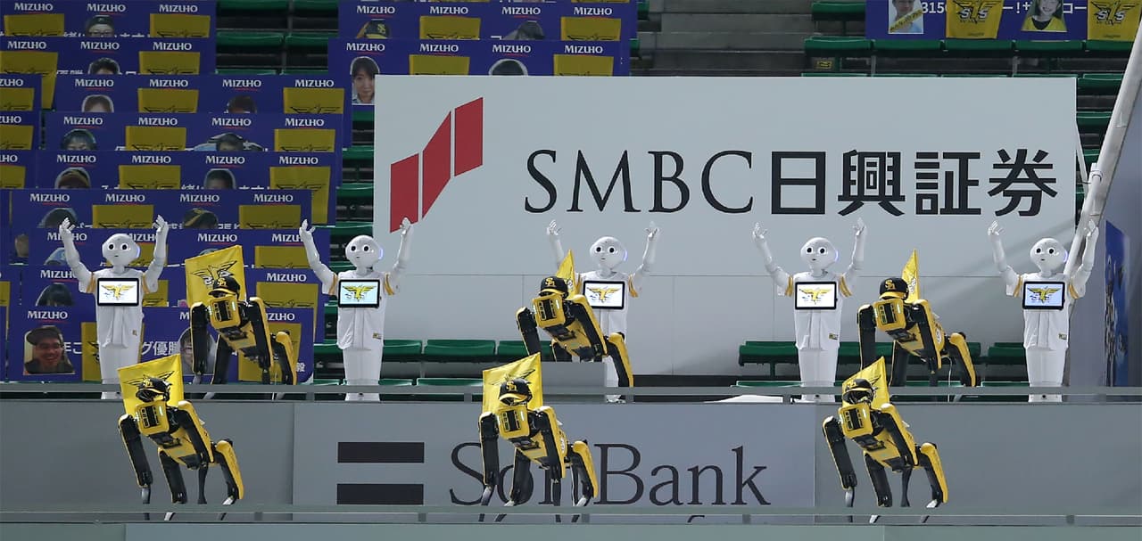 El 2020 lo alteró todo en unos cuantos meses. En un intento de recobrar cierta normalidad, una vez que los deportes pudieron reanudarse en
<a href="https://www.univision.com/temas/japon">Japón</a>, aunque sin presencia de aficionados en las gradas de los estadios, los equipos se pusieron creativos para darle un poco de color a los cotejos. En imagen, los robots humanoides de SoftBank Corp, Pepper (blanco) y los robots de Boston Dynamics SPOT (amarillo) bailan y cantan antes del partido de la liga de béisbol profesional Nippon entre SoftBank Hawks y Rakuten Golden Eagles.
<br>