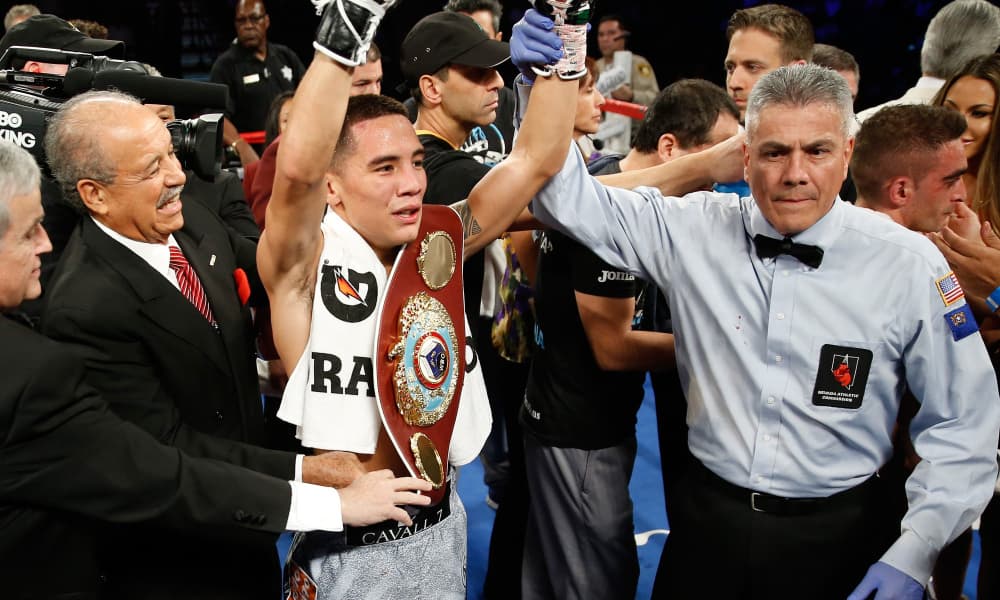 LAS VEGAS, NV - JULY 23: Oscar Valdez Jr. (C) of Mexico poses with the referee Russell Mora after defeating Matias Rueda of Argentina in a fight for a vacant WBO featherweight title at the MGM Grand Garden Arena on July 23, 2016 in Las Vegas, Nevada. (Photo by Steve Marcus/Getty Images) ORG XMIT: 640949811 ORIG FILE ID: 579388380