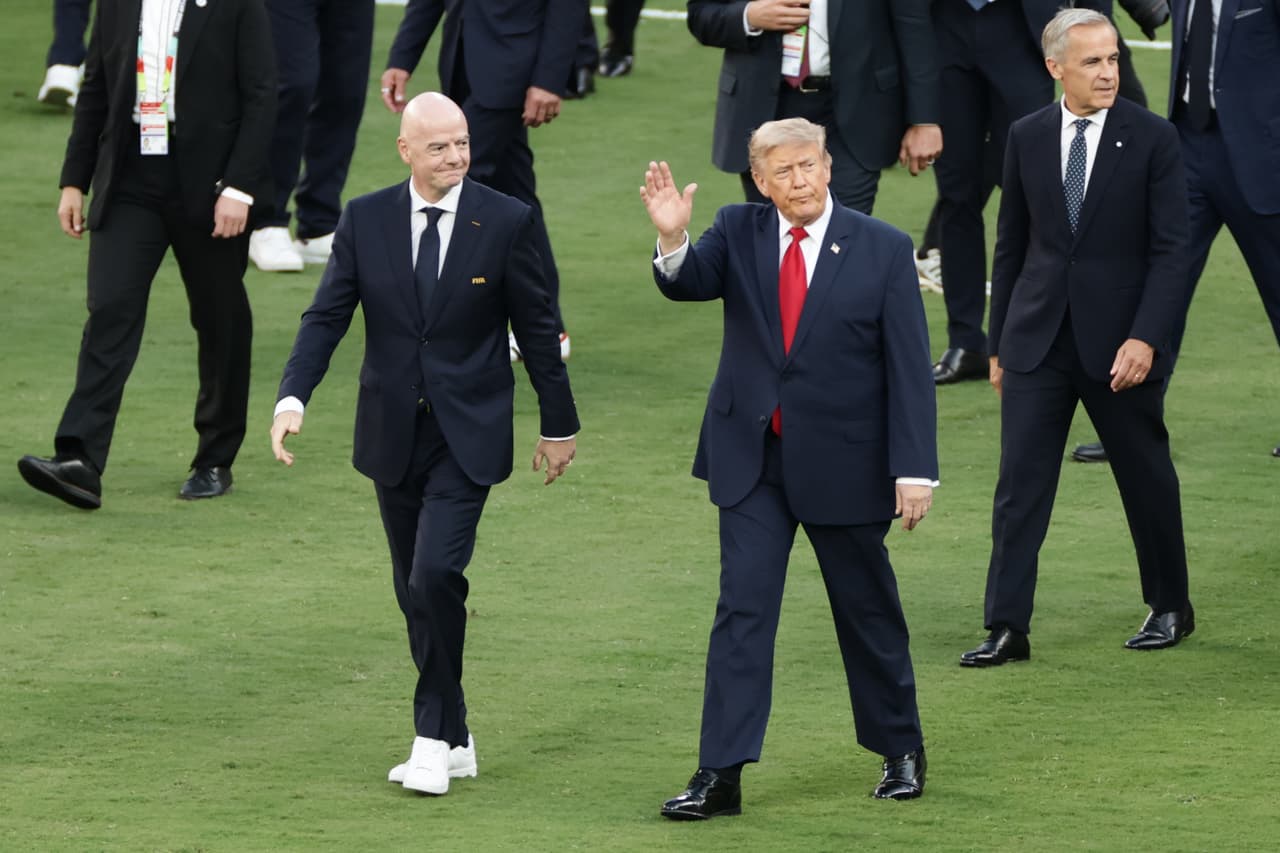 FIFA President Gianni Infantino, left, and President Donald J. Trump walk on the pitch after the World Cup final soccer match between Spain and Argentina in East Rutherford, N.J., near New York, Sunday, July 19, 2026. (AP Photo/Adam Hunger)