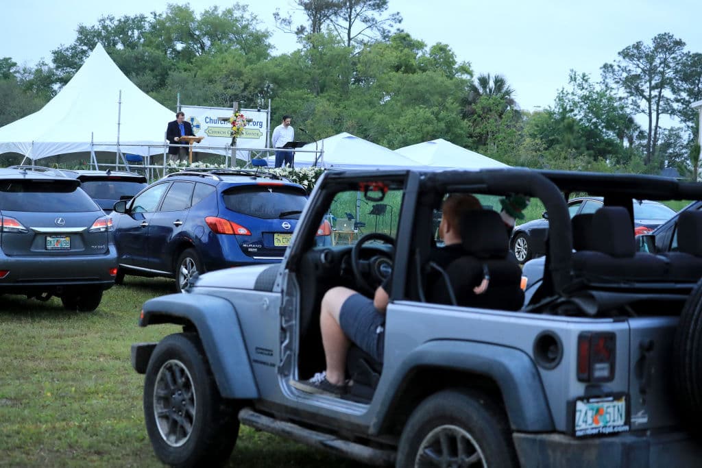 JACKSONVILLE BEACH, FLORIDA - APRIL 12: People attend a drive-in Easter service at the Church of Our Savior amid the Coronavirus outbreak on April 12, 2020 in Jacksonville Beach, Florida. Gov. Ron DeSantis has not closed places of worship, but is still urging residents to adhere to social distance guidelines. (Photo by Sam Greenwood/Getty Images)